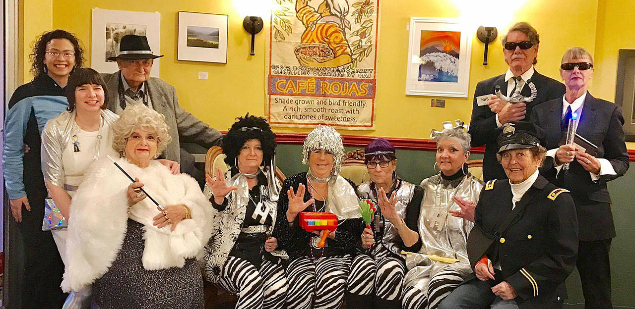 The 2018 “Whodunnit Downtown? — The Case of the Mistaken Tin Foil Hat” suspects and storyteller include, back row, from left, Adriana Hashem, Renne Emiko Brock, Joe Borden Jeff Perry and Crystal Stout, with, front row, from left, Tawana Borden, Cindy Weston, Anne Burkhardt, Kelly Olson, Mary Higley and Emily Westcott. (Dianne Drake)