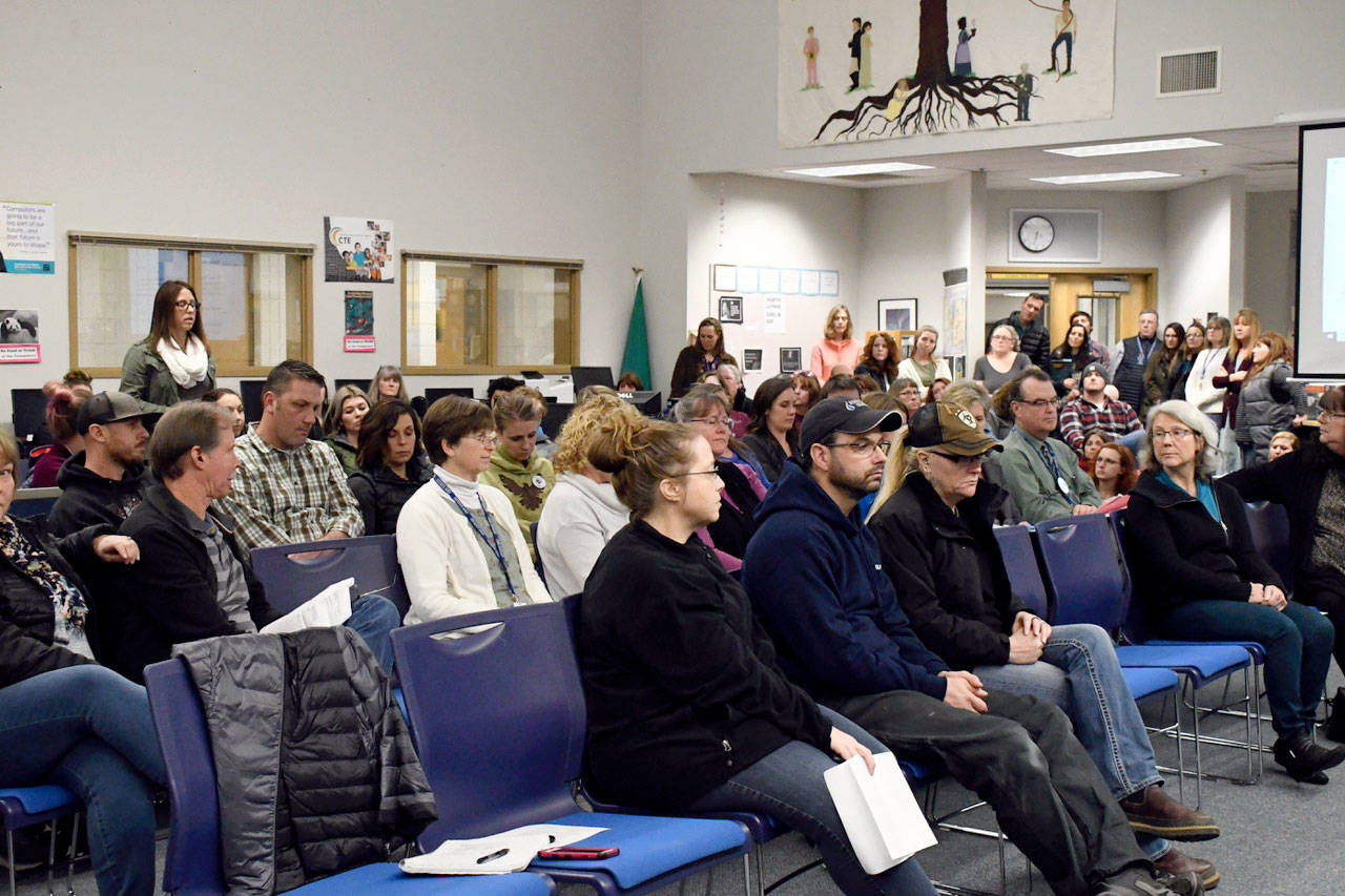 Parent Brittany Huntingford, at rear, asked the Chimacum School Board to reconsider a vote on the resignation of Chimacum Creek Primary Principal Kalie Enlow at a meeting Wednesday night. Board President Mike Gould explained that personnel matters would not be discussed and that information about decisions are protected by law. (Jeannie McMacken/Peninsula Daily News)