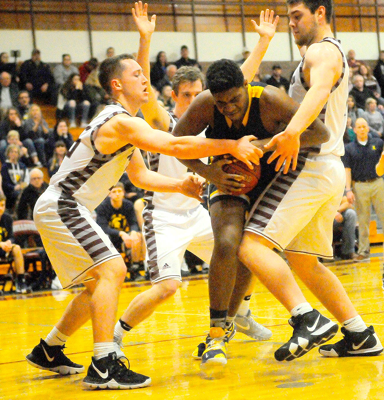 Hasani Grayson /Grays Harbor News Group                                Forks’ Trey Baysinger, center, is swarmed by Montesano defenders.