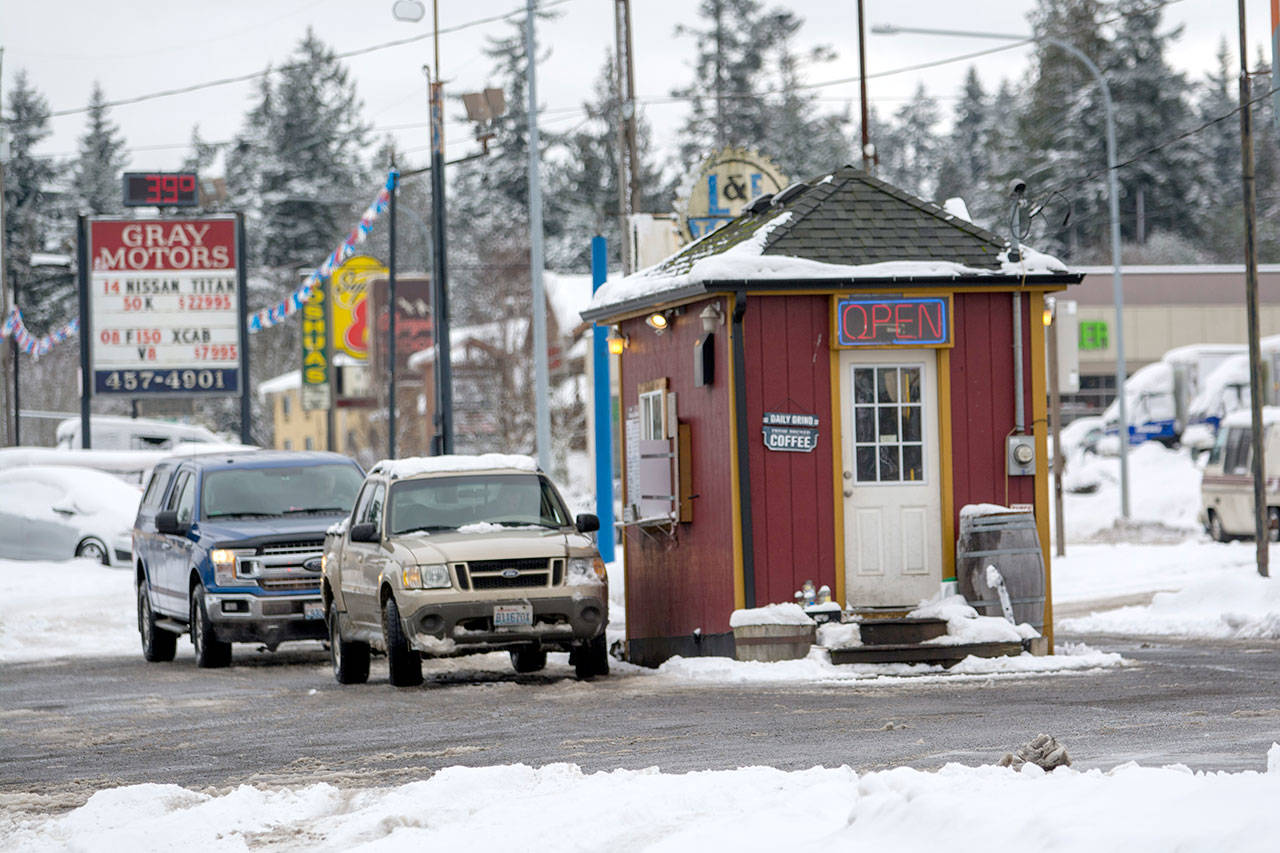 Customers wait in line at Daily Grind in Port Angeles on Monday. Daily Grind is one of three coffee shops in Port Angeles offering free drinks to first responders after community donations came in. (Jesse Major/Peninsula Daily News)