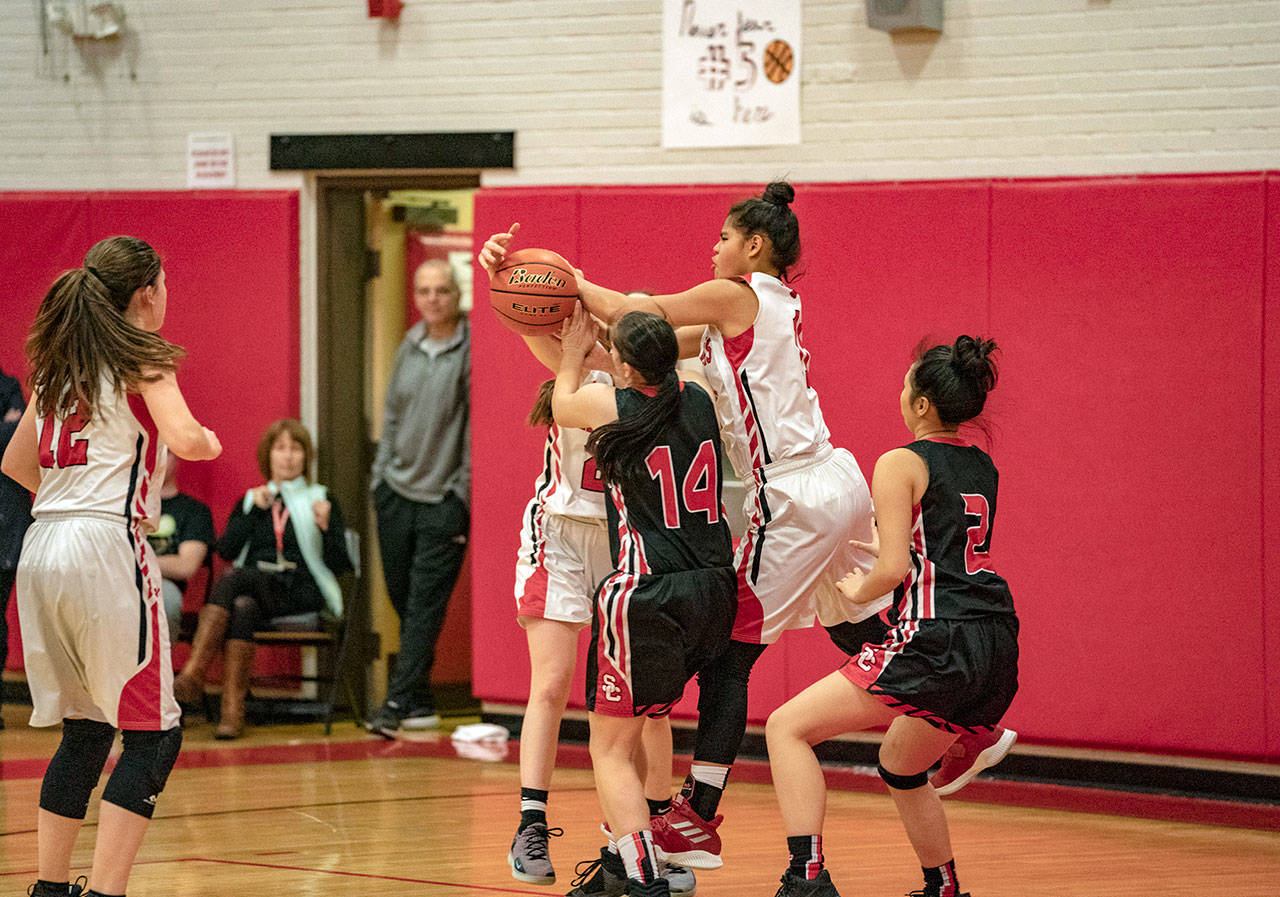 Steve Mullensky/for Peninsula Daily News Port Townsend’s Gina Brown goes after a rebound during a district play-in game against the Seattle Christian Warriors on Wednesday in Port Townsend.