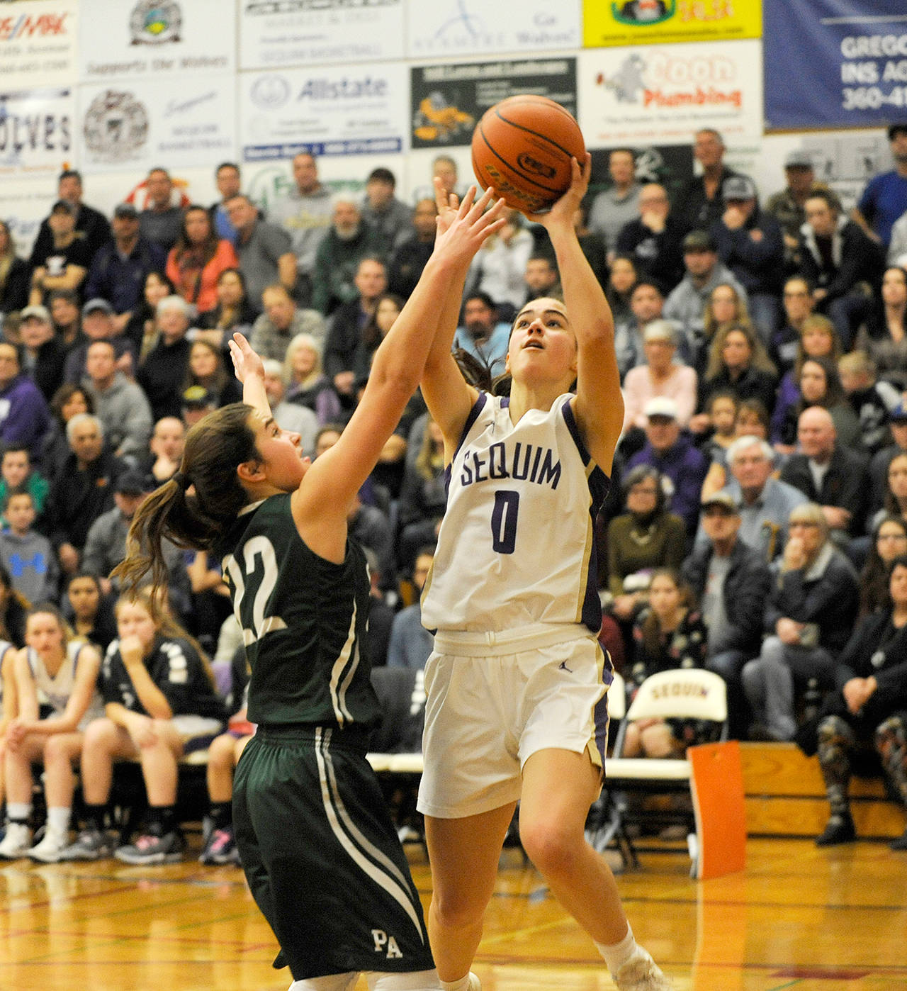 Michael Dashiell/for Olympic Peninsula News Group Sequim’s Hope Glasser, right, puts up a shot while defended by Port Angeles’ Eve Burke during a game last month. Both teams are in action this weekend during the Class 2A State Regional Round.