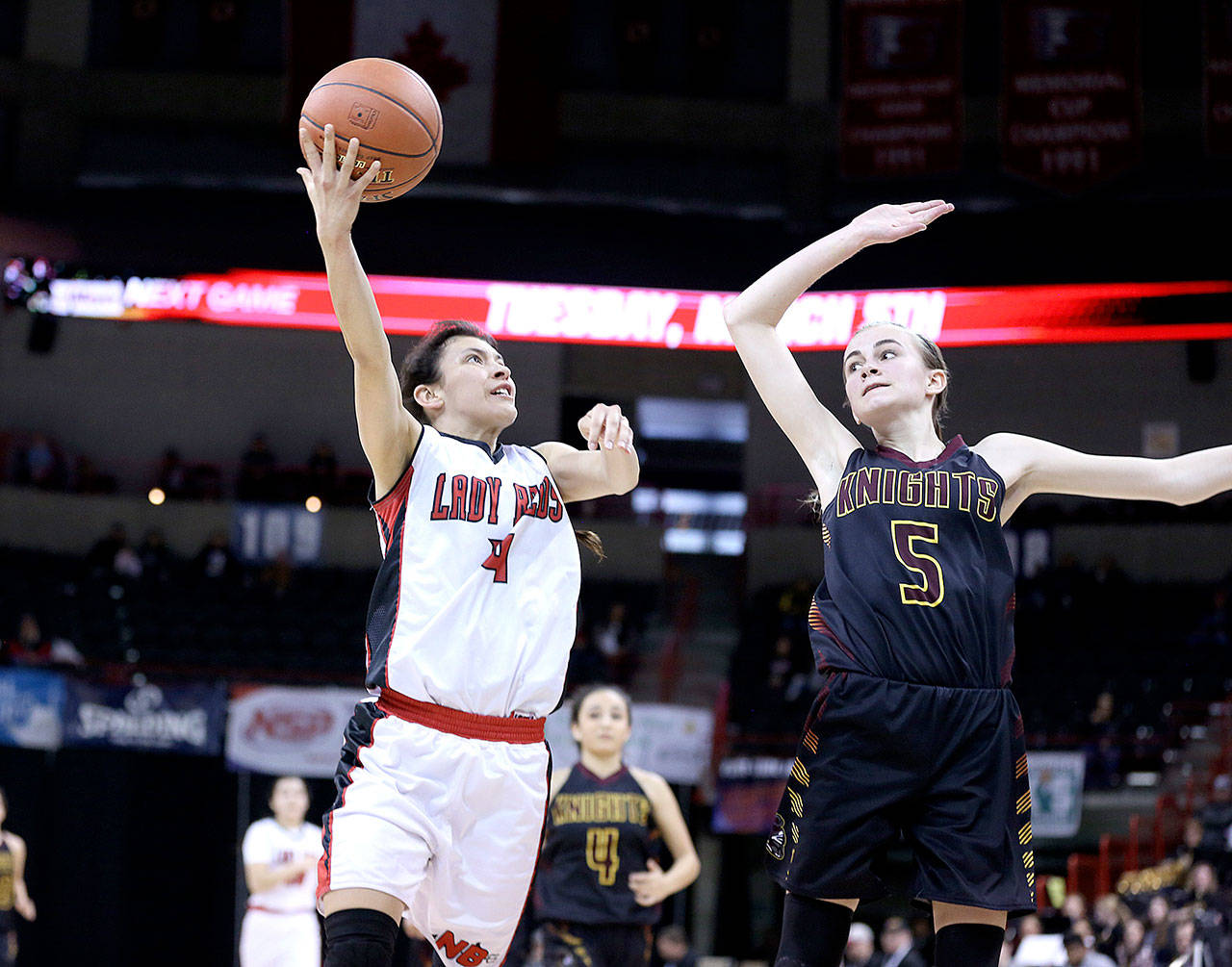 Neah Bay’s Laila Greene takes a shot over Sunnyside Christian’s Sydney Banks at the girls 1B state basketball tournament in Spokane. The Red Devils won 62-51 and will be playing in the state semifinals against No. 1 Colton today. (Chris Johnson/for Peninsula Daily News)