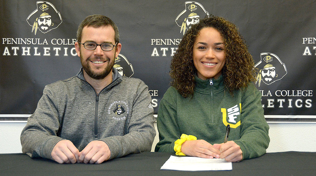 Peninsula College women’s soccer head coach Kanyon Anderson and player Halle Watson at Watson’s signing ceremony last week. The Peninsula College defensive back will play next year for the University of San Francisco.