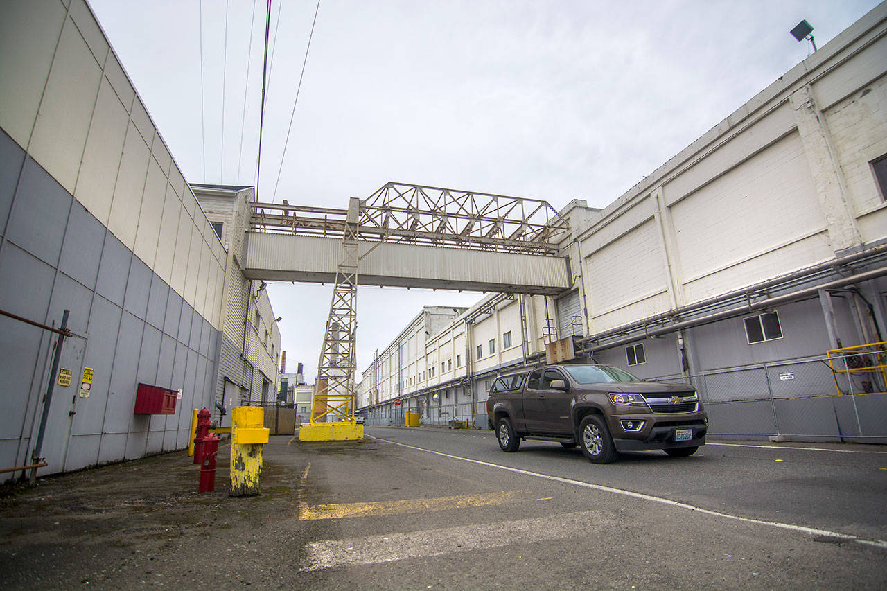 A vehicle passes through the McKinley Paper Company mill in Port Angeles on Monday. The company has applied for permits to install new equipment. (Jesse Major/Peninsula Daily News)
