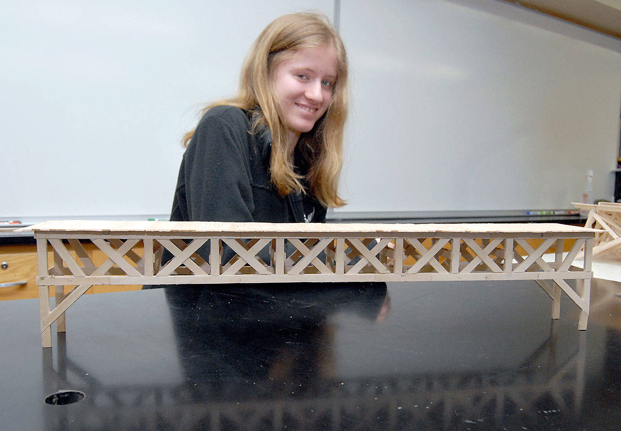 Port Angeles High School senior Skyler Sullivan shows off her award-winning popsicle stick bridge, which held 395 pounds, in a recent bridge competition in Seattle. (Keith Thorpe/Peninsula Daily News)