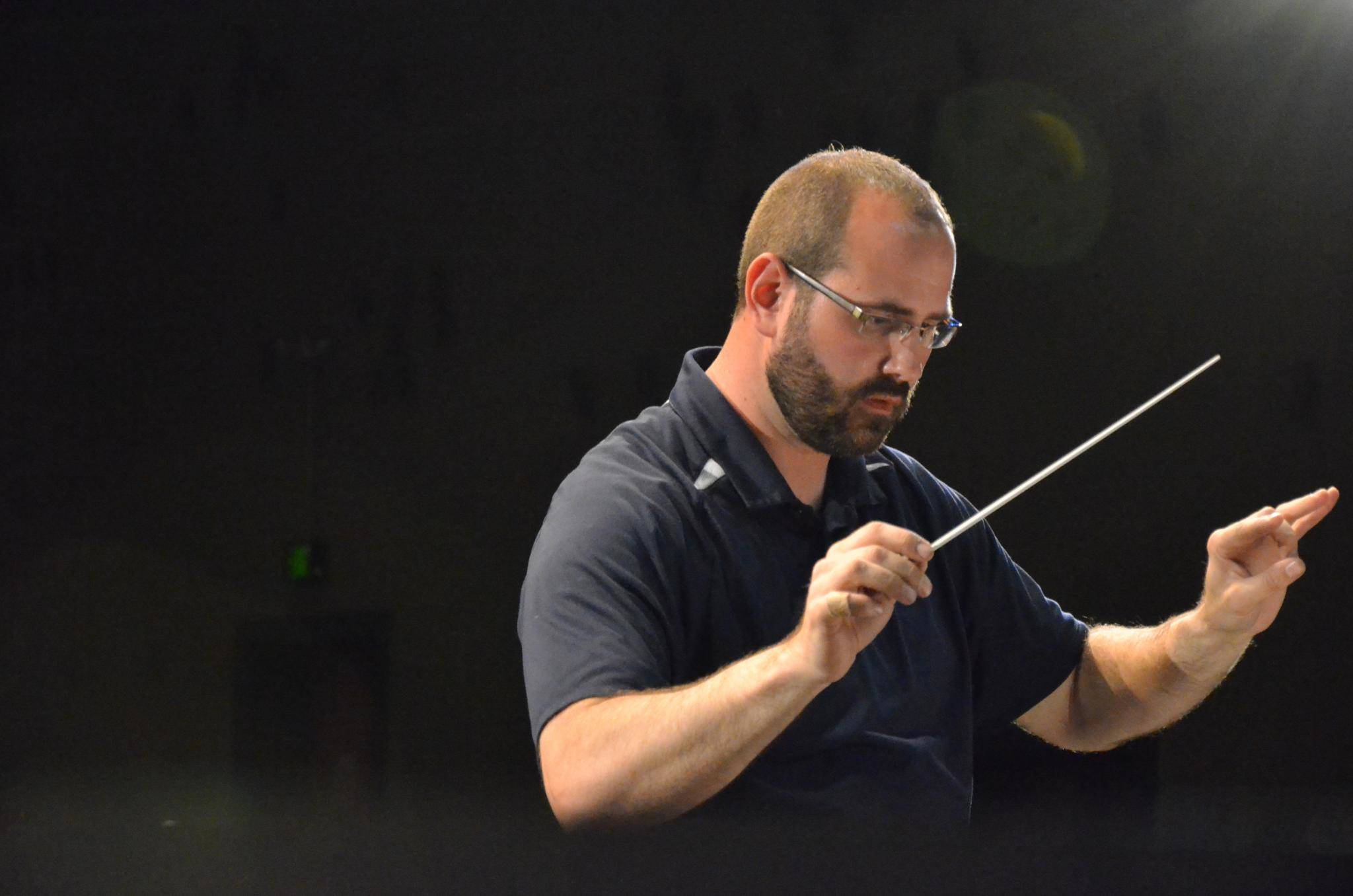 Sequim City Band’s Tyler Benedict conducts a during dress rehearsal for a May 2014 concert. Photo courtesy of Sequim City Band