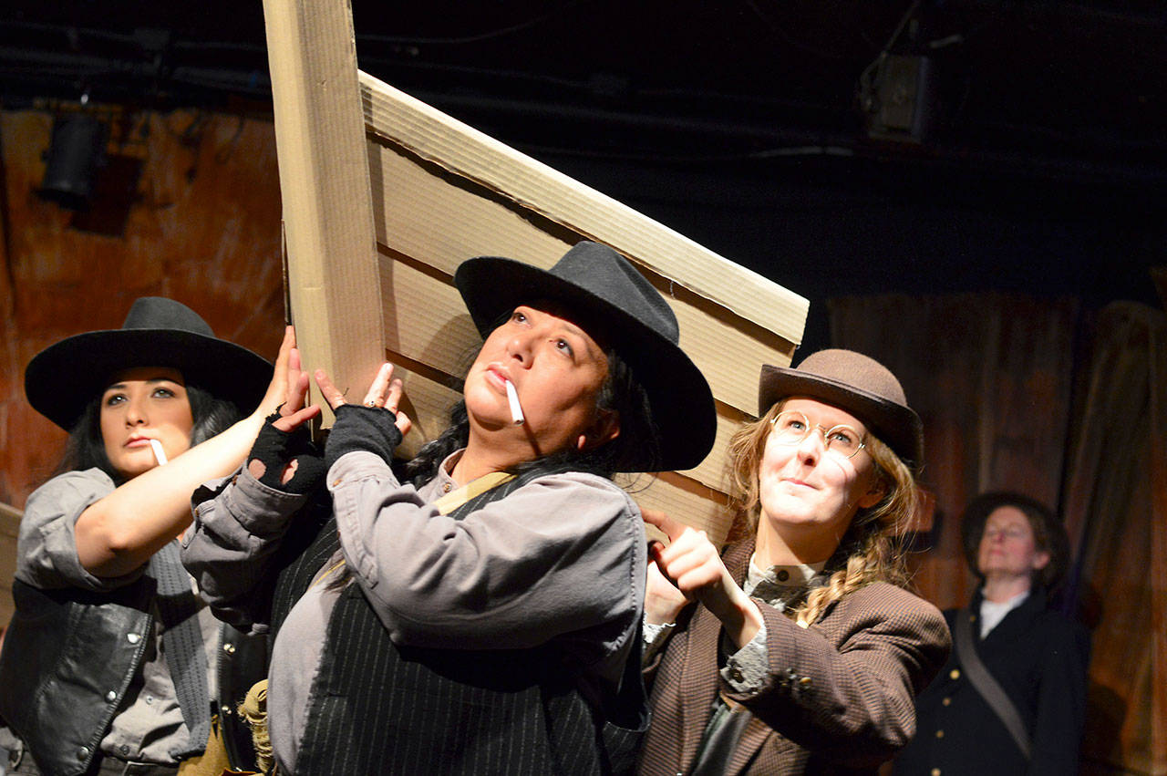 Lifting their vessel to portage in “Men on Boats” are, from left, Christa Holbrook, Consuelo Aduviso and Maggie Jo Bulkley. “Men,” a reimagined version of the Powell expedition into the Grand Canyon, opens this week at Port Townsend’s Key City Playhouse. (Diane Urbani de la Paz/for Peninsula Daily News)