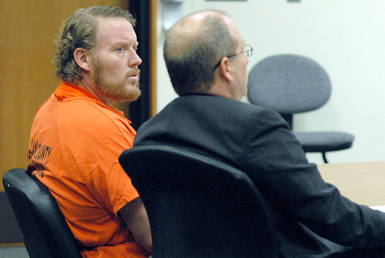 Jason Spaulding, left, sits with attorney Stan Myers during a plea acceptance hearing Wednesday in Clallam County Superior Court in Port Angeles. (Keith Thorpe/Peninsula Daily News)