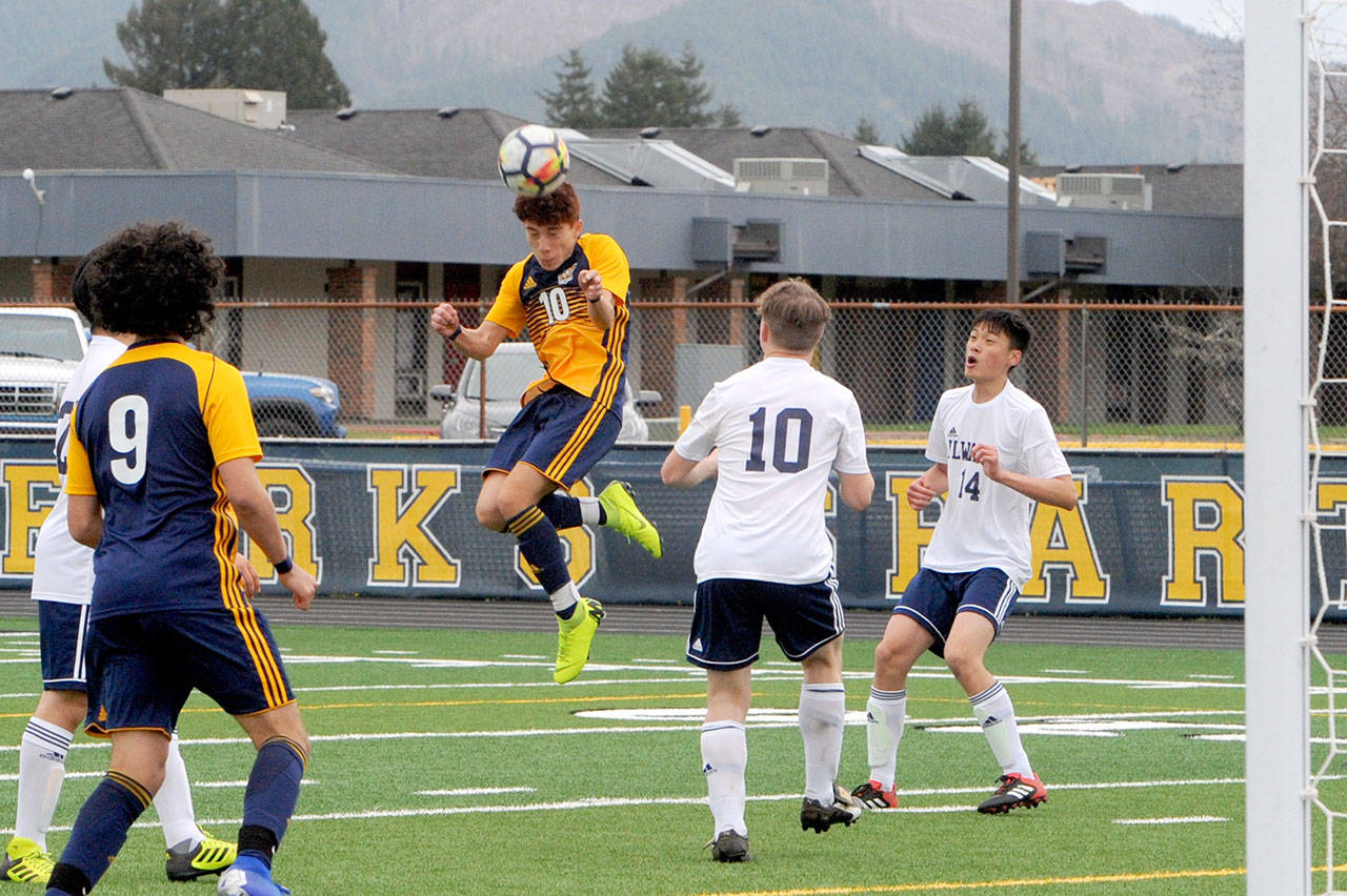 Forks’ Oscar Gonzalez (10) heads the ball during Forks’ 8-1 win over Ilwaco at Spartan Stadium. Looking on are Forks Tony Hernandez-Flores (9) and Ilwaco’s Brandon Duke (10) and Miguel Hernandez (14). (Lonnie Archibald/for Peninsula Daily News)