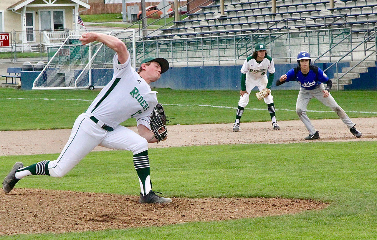 Port Angeles pitcher Ethan Flodstrom throws to the plate against North Mason on Monday. Flodstrom allowed no runs in three innings. North Mason’s Troy McCormick is watched carefully by the Port Angeles first baseman Bo Bradow. (Dave Logan/for Peninsula Daily News)