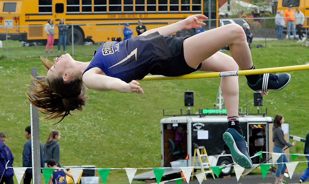 Keith Thorpe/Peninsula Daily News Sequim’s Abby Schroeder clears the bar at 5 feet to win the girls high jump during Thursday’s meet at Port Angeles High School.