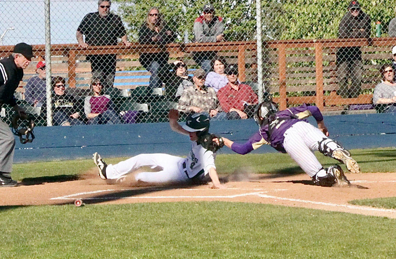 Wyatt Hall scores Port Angeles’ first run in a 3-2 comeback win over North Kitsap that clinched a repeat Olympic League title for the Roughriders. (Dave Logan/for Peninsula Daily News)