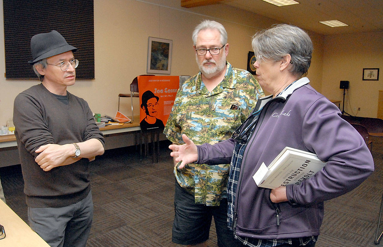 Author/illustrator Joe Sacco, left, meets with Brian Doerter and Gloria Moe of Port Angeles prior to Sacco’s presentation as a Peninsula College writer in residence on Wednesday at the Elwha Klallam Heritage Center in Port Angeles. (Keith Thorpe/Peninsula Daily News)