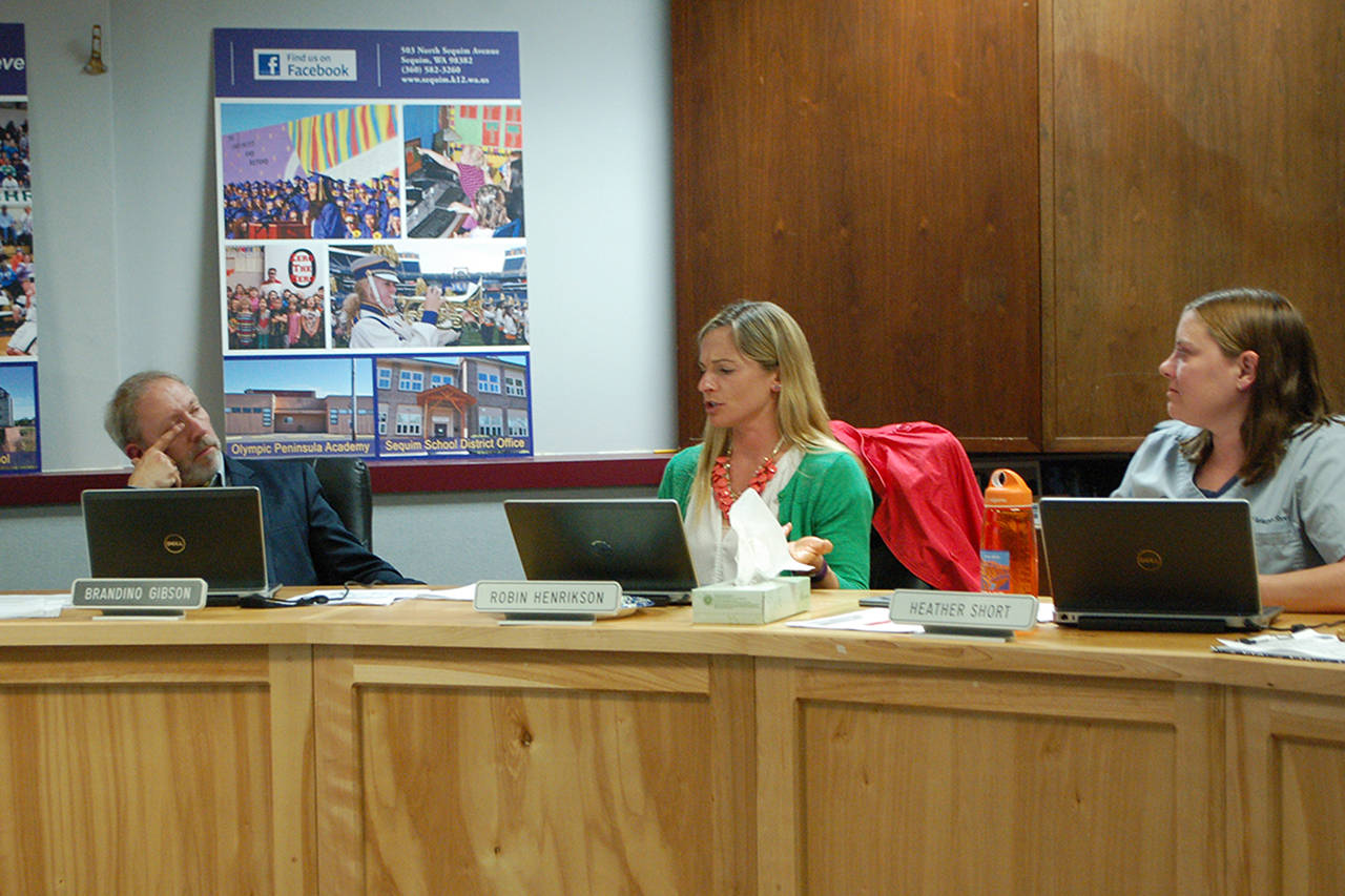 Sequim School Board directors Heather Short, Robin Henrikson, and Brandino Gibson discuss the selection of a search firm to find a replacement for outgoing Superintendent Gary Neal. (Conor Dowley/Olympic Peninsula News Group)