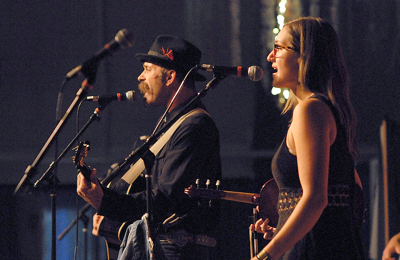 Scott Sullivan, left, and Chandra Johnson of the Port Angeles-based Crushwater kick off the Main Stage schedule in Vern Burton Community Center on Friday night at the Juan de Fuca Festival of the Arts in Port Angeles. (Keith Thorpe/Peninsula Daily News)