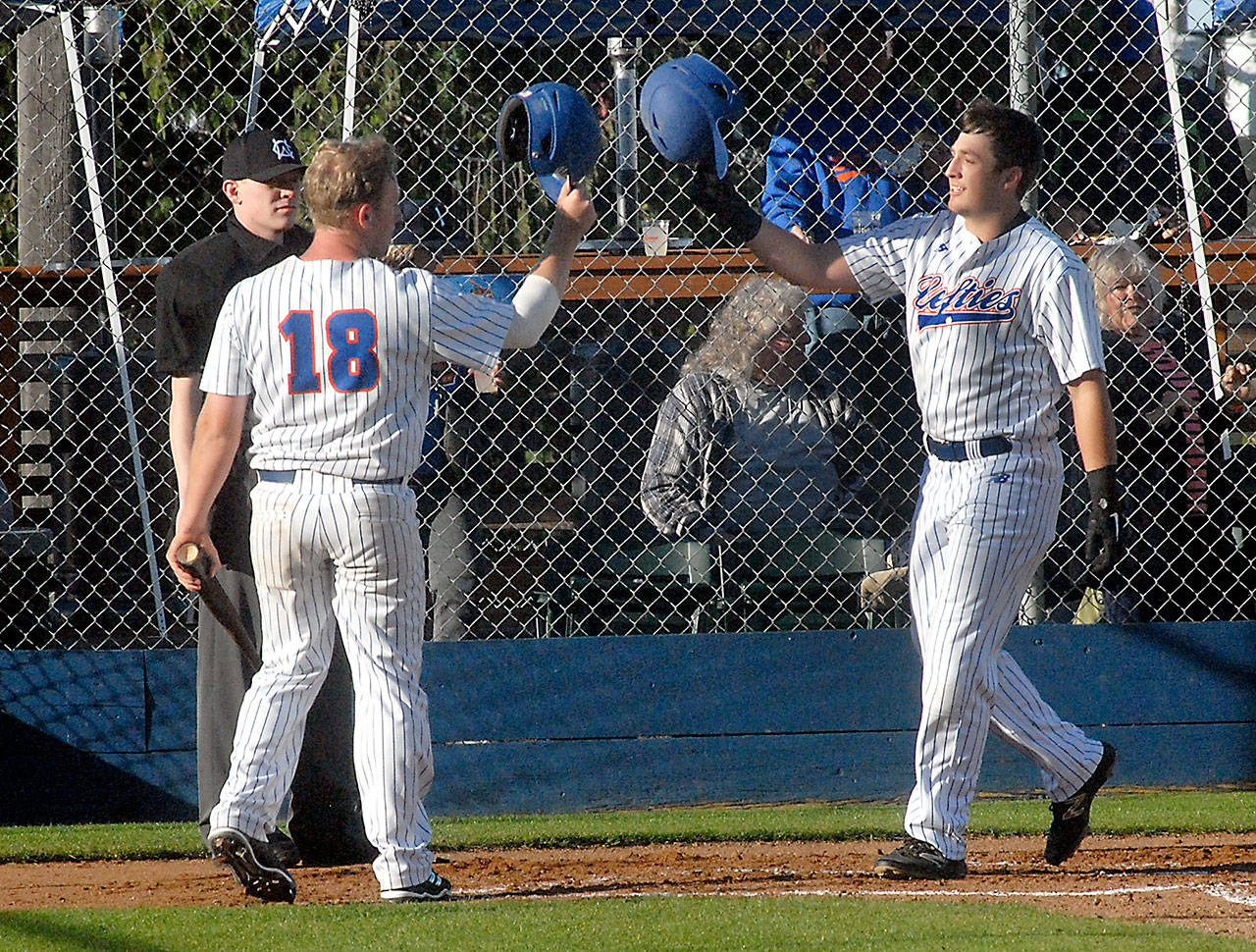 Lefties third baseman Evan Hurn, right, is greeted by fellow baserunner Zander Marco at home plate after Hurn’s two-run homer in the second inning on Friday night at Port Angeles Civic Field.                                Keith Thorpe/Peninsula Daily News