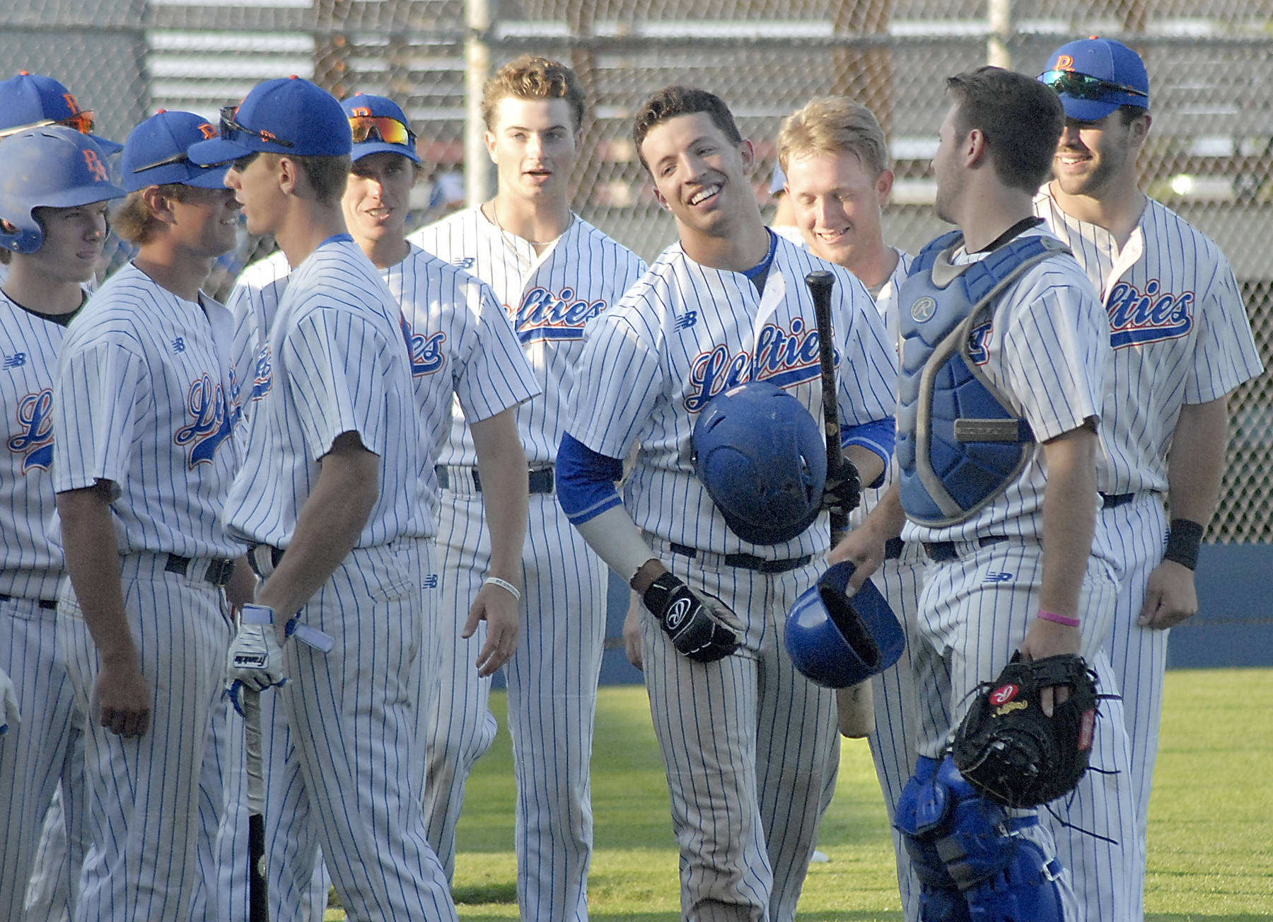 <strong>Keith Thorpe</strong>/Peninsula Daily News                                Lefties center fielder Nick Diponzio, center, is surrounded by his teammates after homering in the third inning against the Northwest Honkers on Thursday at Port Angeles Civic Field.