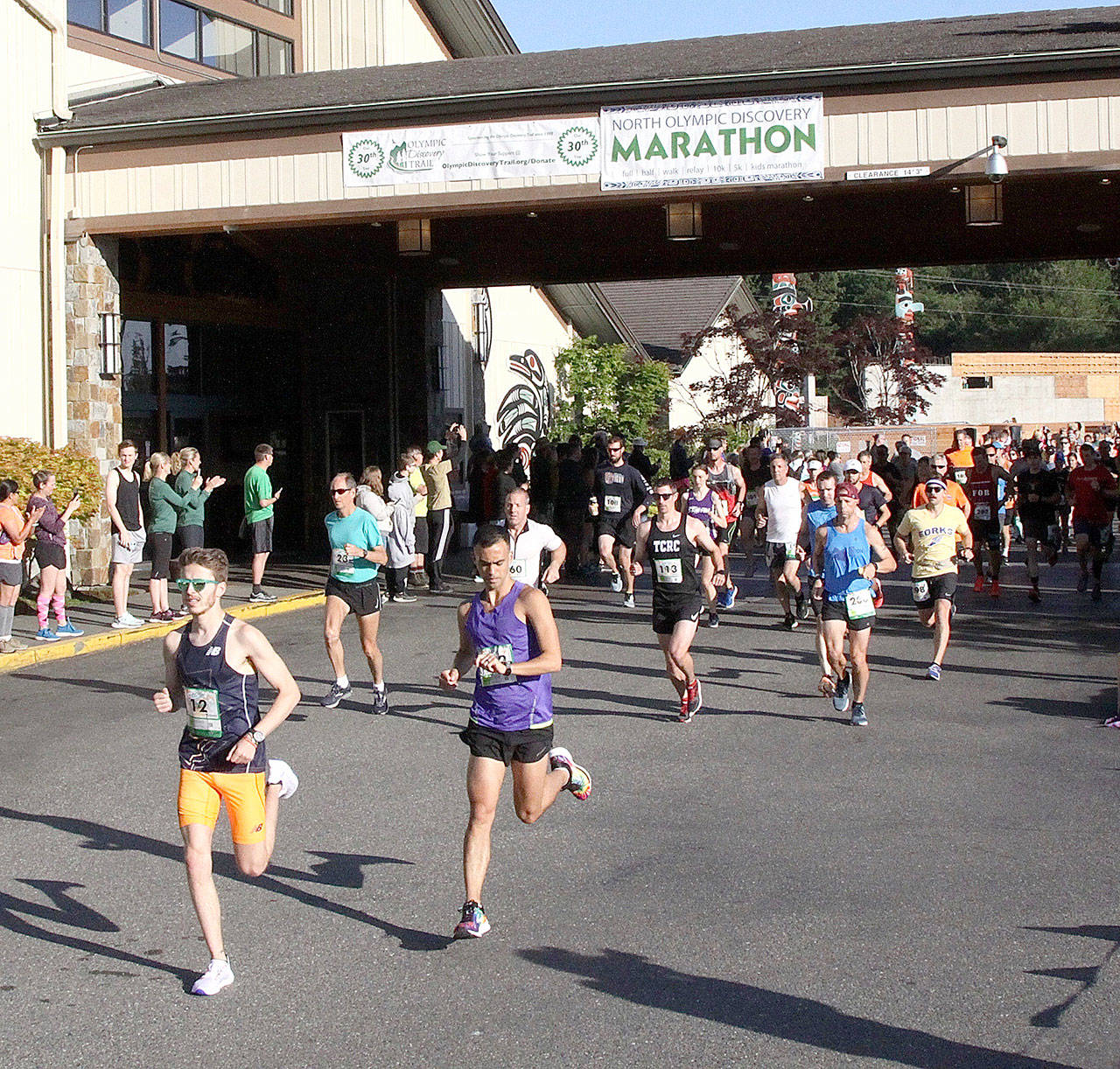 Dave Logan/for Peninsula Daily News Runners take off at the start of the North Olympic Discovery Marathon early Sunday morning. In the lead is Mikey Cobb of Sequim, who won the race two-and-a-half hours later. To the right is Derek Lactaoen of Seattle, who finished second.