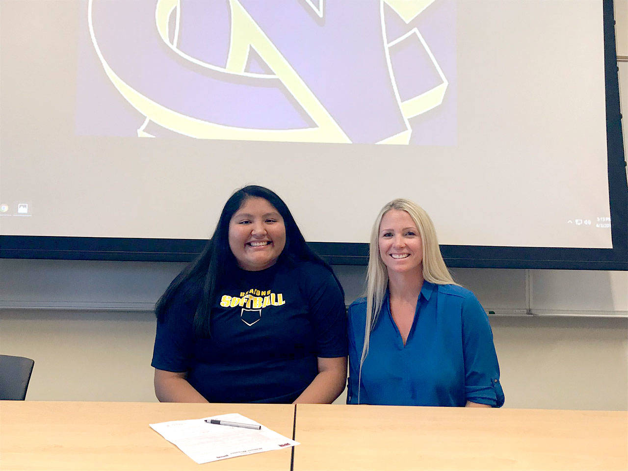 Port Angeles’ Nizhoni Wheeler, left, is joined by Lower Columbia coach Traci Fuller as Wheeler signs to continue her college softball career at Northwest Christian University in Eugene, Ore. Wheeler, a 2017 Port Angeles High School graduate, has played basketball and softball at Lower Columbia the last two seasons.