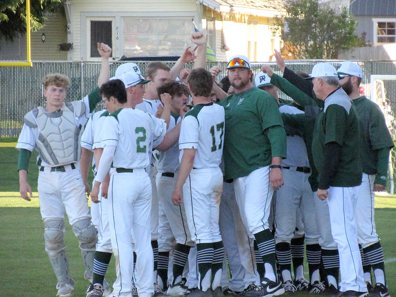 Submitted photo Port Angeles head coach Karl Myers, center, is leaving the program after five seasons, including three as head coach. The Roughriders posted a 52-18 record with three state appearances, back-to-back Olympic League titles and a West Central District championship under Myers.