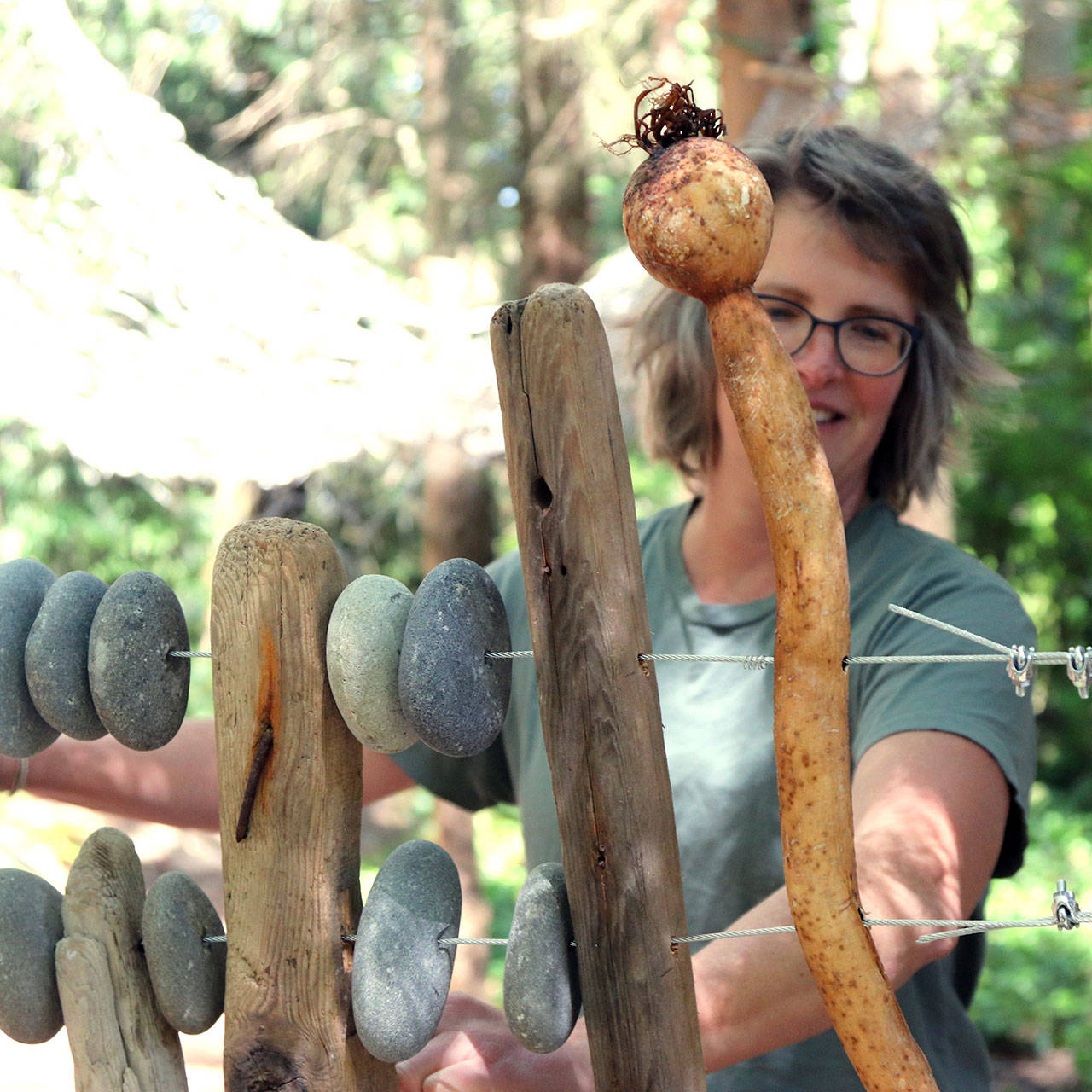 Clea Rome of Port Angeles began installation of her sculpture, “Abacus,” in Webster’s Woods earlier this week. The large piece is among several added to the park for the Solstice Art Festival on Friday and Saturday. (Port Angeles Fine Arts Center)