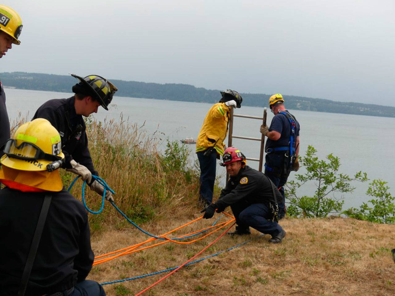 Firefighters work to rescue a 90-year-old man from a cliff side on Marrowstone Island. (East Jefferson Fire-Rescue)