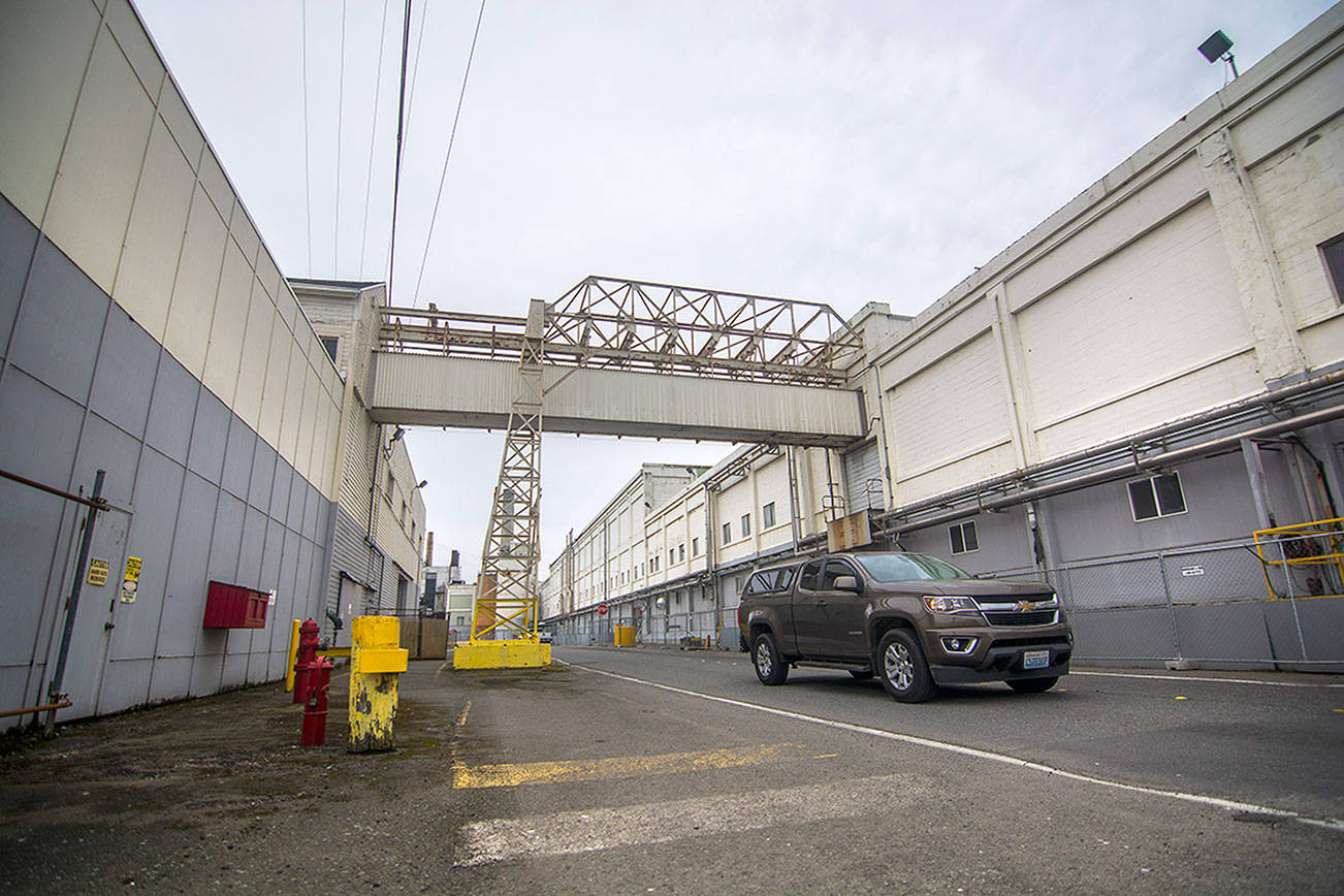 A vehicle passes through the McKinley Paper Company mill in Port Angeles on Monday. (Jesse Major/Peninsula Daily News)