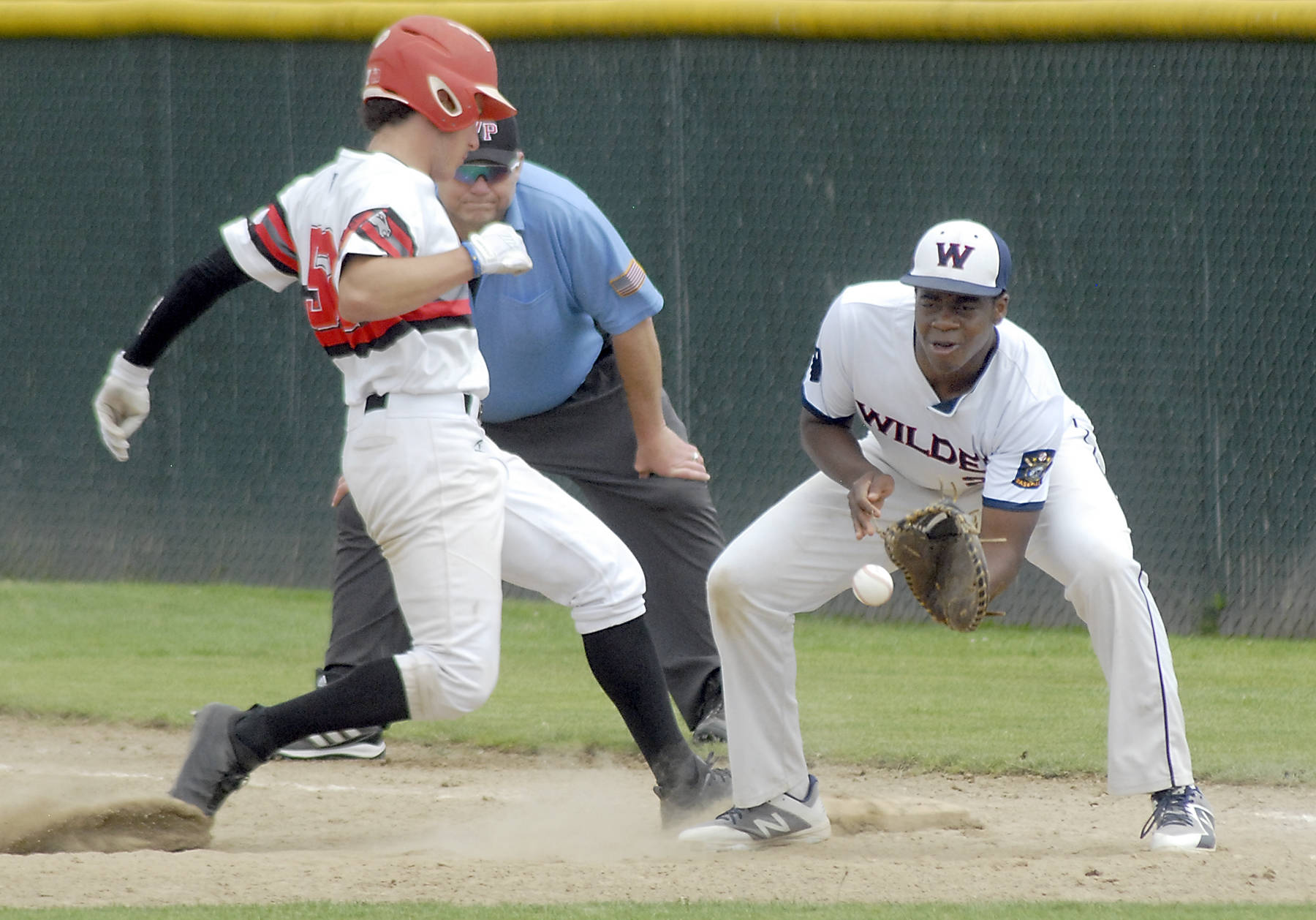 <strong>Keith Thorpe</strong>/Peninsula Daily News                                Wilder Junior first baseman Trey Baysinger, right, tries to catch Australia White’s Charlie Cullins off the bag in the fourth inning on Wednesday at Volunteer Field in Port Angeles.