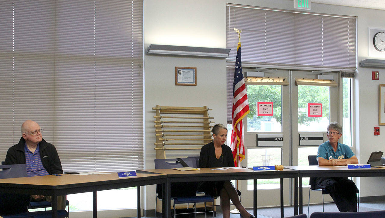 Chimacum School Board members, from left, Jake McKay, Sarah Martin and Mike Raymond listen at their July 10 meeting where the 2019-20 budget was initially presented. (Zach Jablonski/Peninsula Daily News)