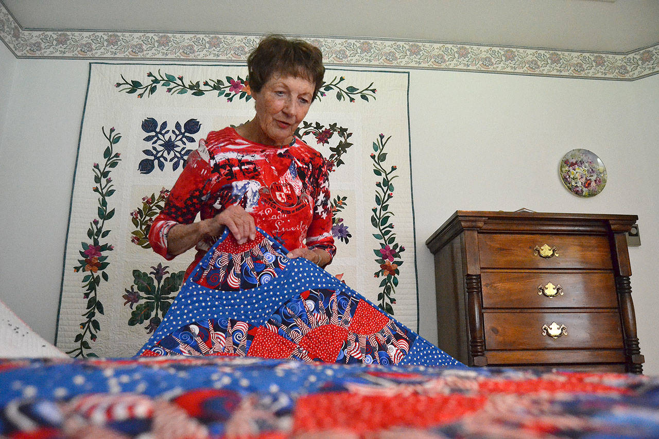 Karen Clatanoff said her “New York Beauty” quilt was one of her tougher ones to complete because of its points and many triangles. (Matthew Nash/Olympic Peninsula News Group)