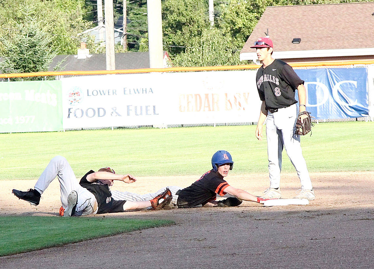 The Lefties’ Gavin Rork is safe at second after being nearly picked off at first base as he made it to second base in a rundown. In on the play are Corvallis second baseman Matt Cretler and shortstop Brooks Lee (8). Rork later stole third base and was out trying to steal home. (Dave Logan/for Peninsula Daily News)