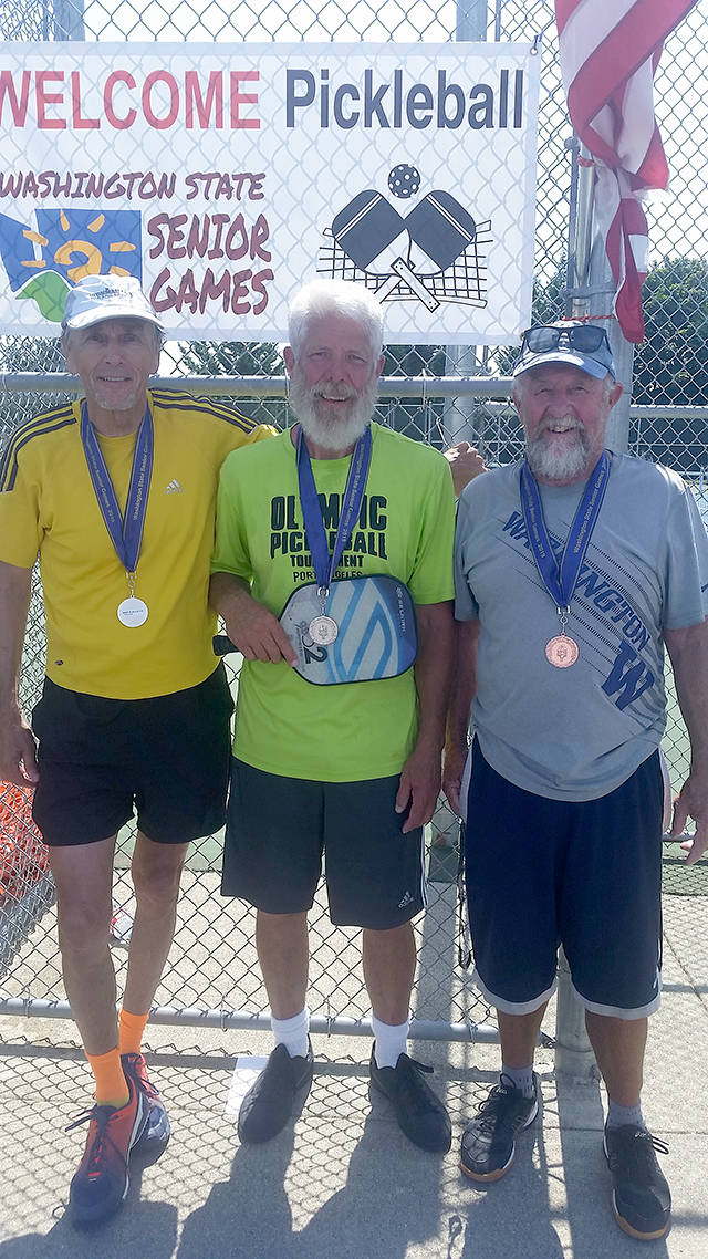 Port Angeles pickleball player Steve Bennett, center, won the gold medal in the age 70-74 skill level 3.5 division at the Washington State Senior Games in Lacey. Bennett was among many North Olympic Peninsula pickleballers to medal at the competition. See results are on page B2.