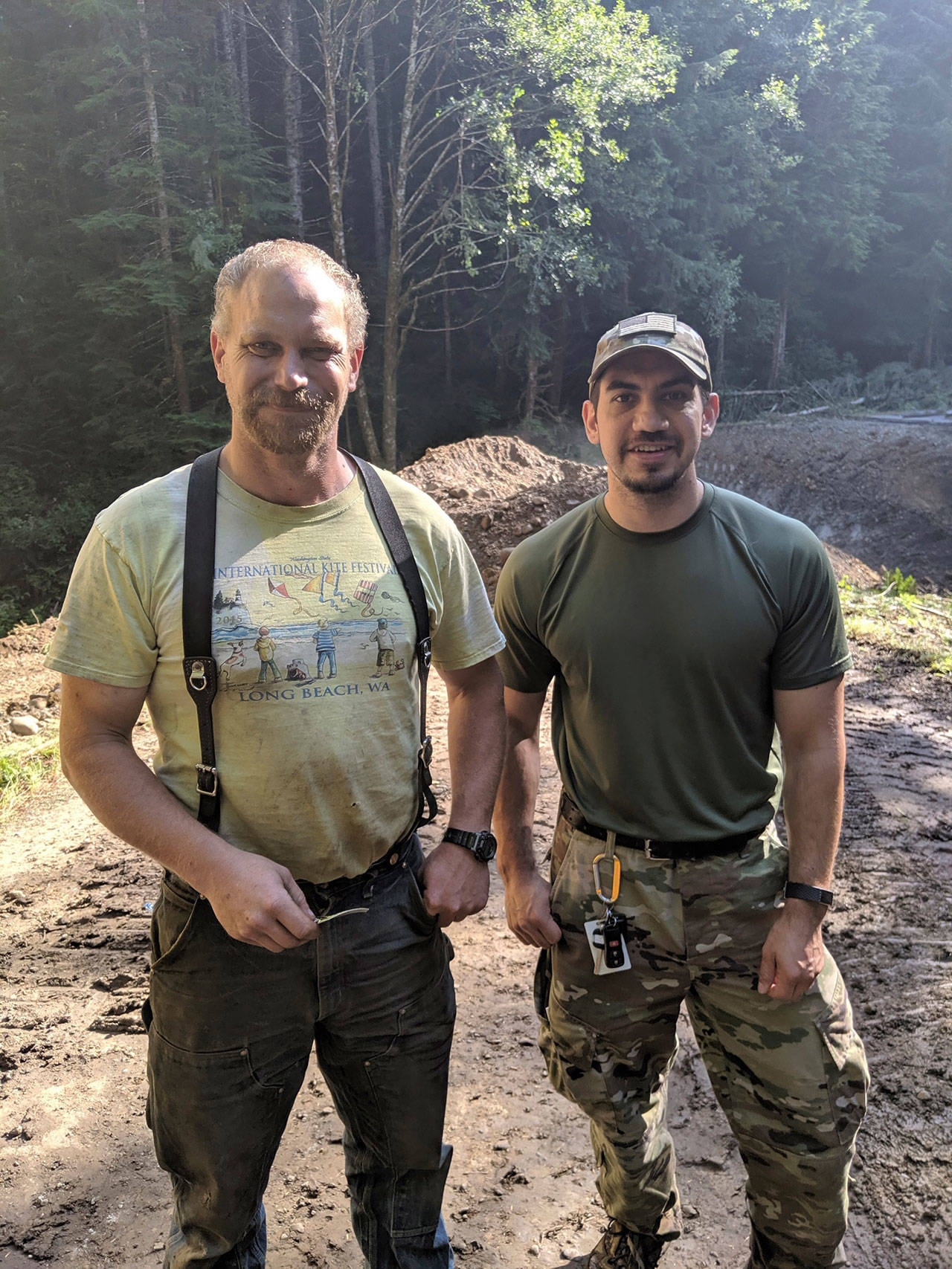 Joel Bruch of Bruch and Bruch Construction in Port Angeles, left, is seen with William Flores of the Olympic Corrections Center Inmate Recovery Team after helping in the safe apprehension of escaped prisoner Mark Vannausdle on Tuesday. (Washington State Department of Corrections)