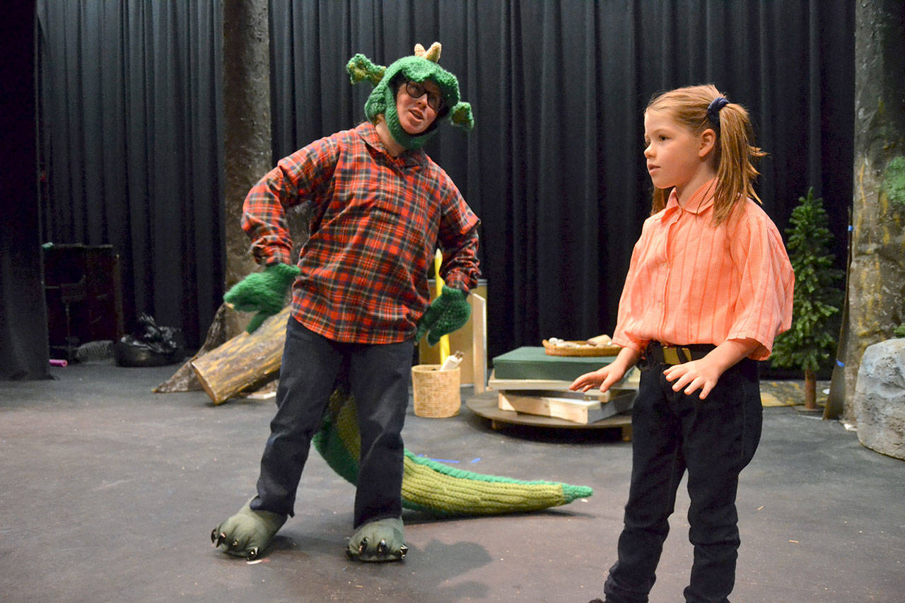 Fred the Dragon (Grayce Houle) talks to Charity (Maia Brewer) about how he’s not afraid of the town’s people and he’d rather eat snacks and write poetry in “The Reluctant Dragon.” Matthew Nash/Olympic Peninsula News Group