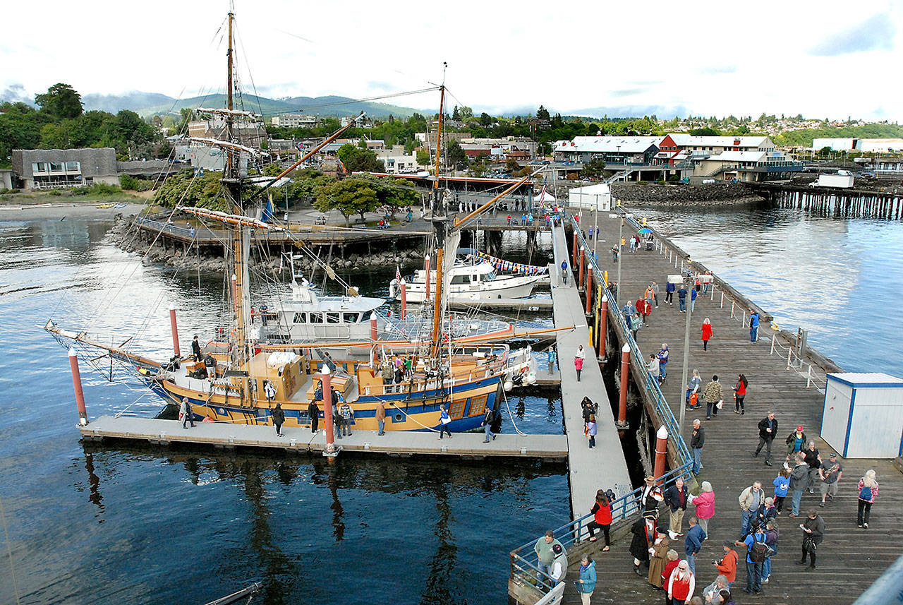 Visitors to the 2018 Port Angeles Maritime Festival make their way around City Pier to examine ships participating in the event, including the tall ship Hawaiian Chieftain, front. (Keith Thorpe/Peninsula Daily News)