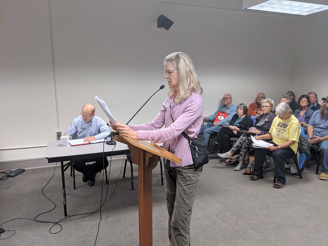 Marta Peterson reads a statement at Monday’s Jefferson County Board of Commissioners meeting from the Jefferson County Environmental Coalition about their plan to protest Pope Resource’s plans to aerial spray glyphosate on its land. (Zach Jablonski/Peninsula Daily News)