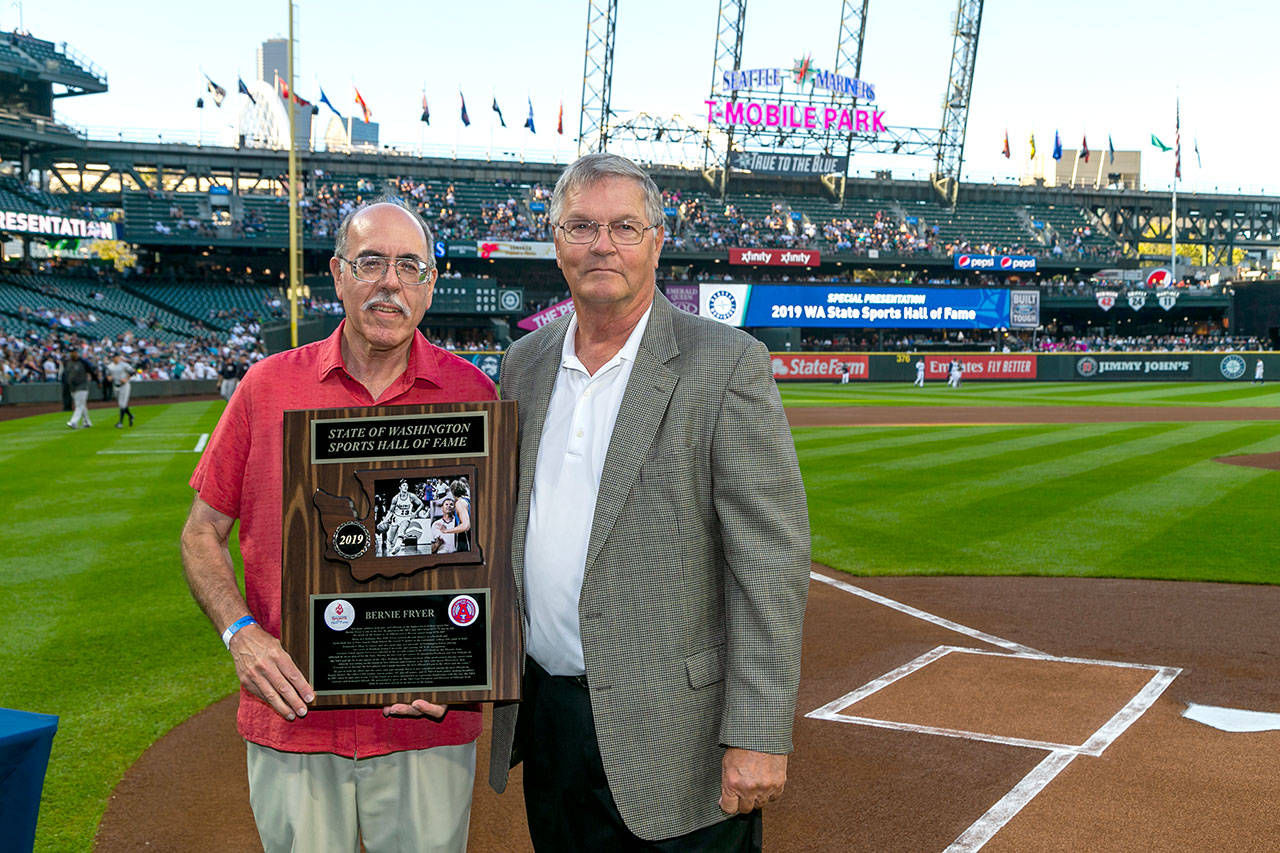 Port Angeles High School and Peninsula college alum Bernie Fryer, right, who played in the NBA and officiated in the league for decades, was inducted into the Washington Sports Hall of Fame by executive director Marc Blau before a recent Seattle Mariners game. Ben VanHouten/Seattle Mariners