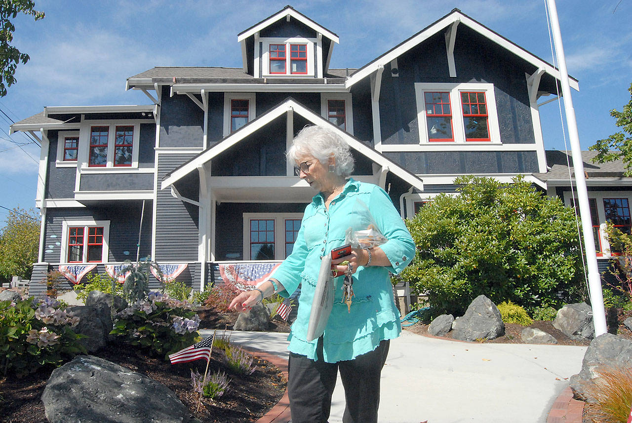 Betsy Reed Schultz, founder of the Captain Joseph House Foundation, points to newly-installed landscaping in front of the former Port Angeles bed and breakfast that is now being converted into a respite house for Gold Star families. (Keith Thorpe/Peninsula Daily News)