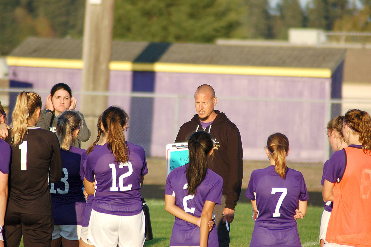 Conor Dowley/Olympic Peninsula News Group Sequim High School girls soccer head coach Derek Vander Velde addresses his team at halftime in their match against Klahowya.