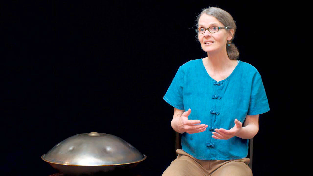 Margo McLoughlin tells a story with her hang, a metal drum, nearby. She will be in Port Angeles on Tuesday.