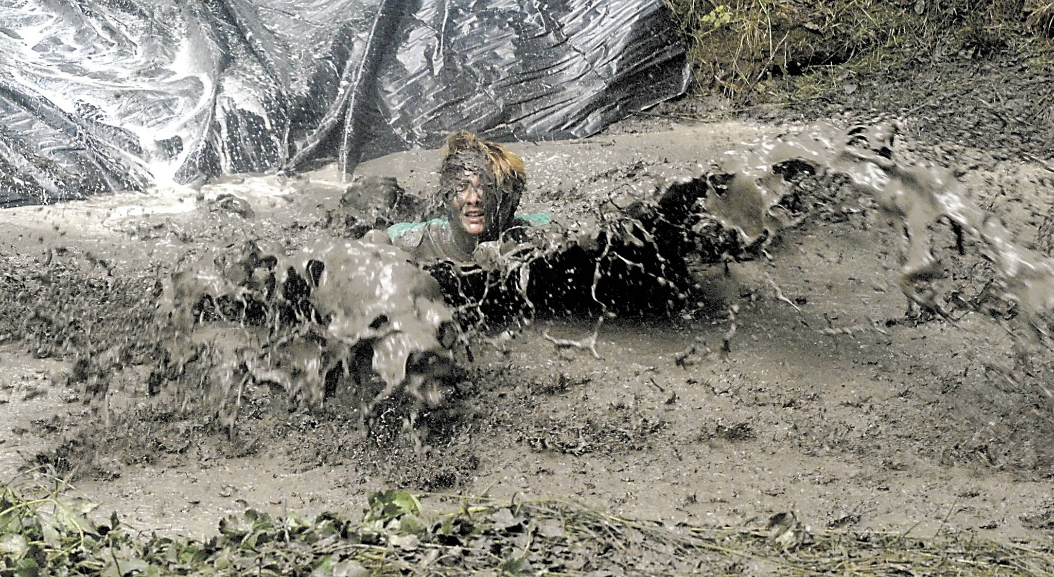 <strong>Keith Thorpe</strong>/Peninsula Daily News                                Danyelle Brannan of Port Angeles emerges from a huge splash of muddy water as she takes part in the 2016 at Extreme Sports Park in Port Angeles.