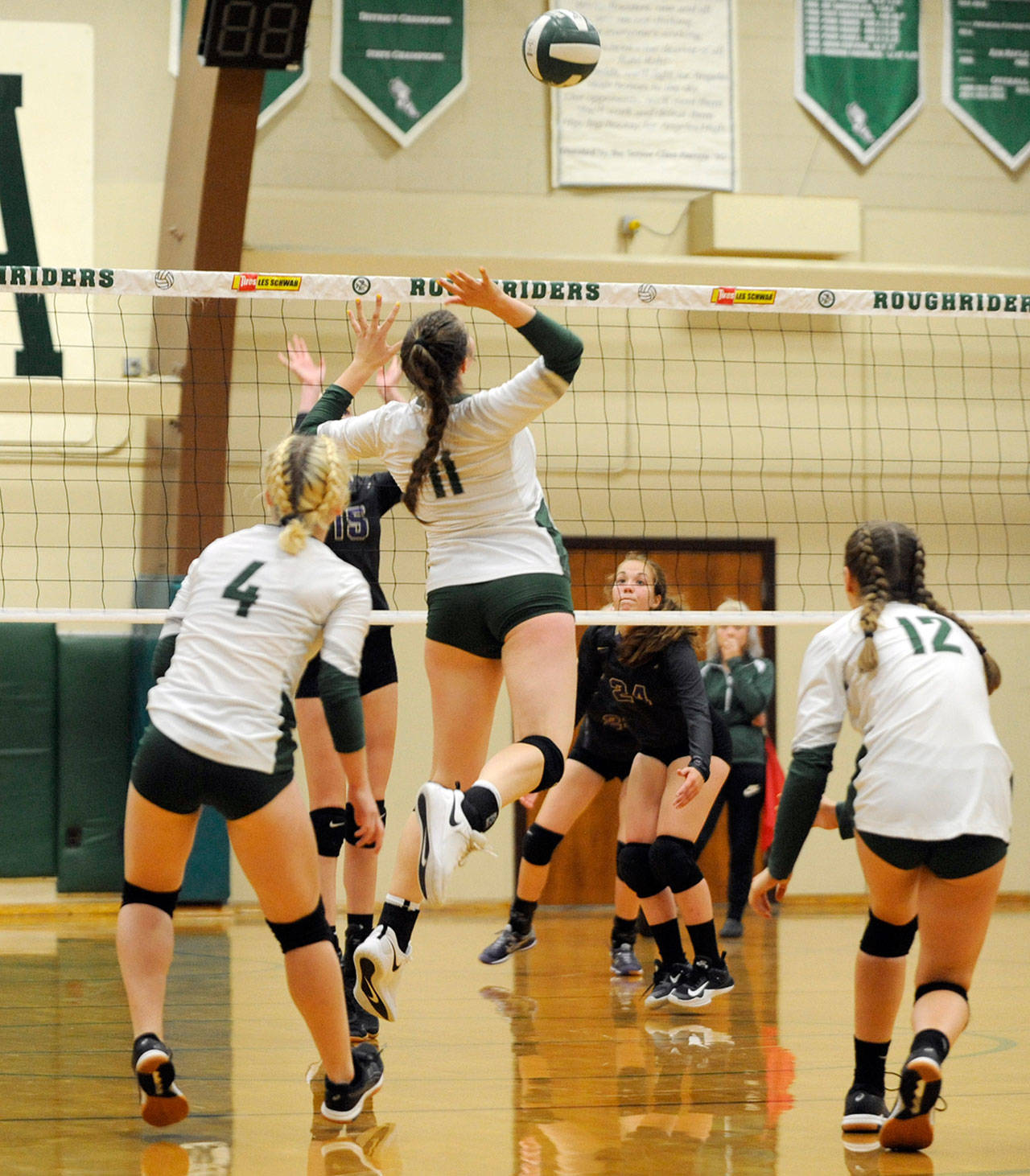 Michael Dashiell/Olympic Peninsula News Group Port Angeles’ Ava Brenkman rises to hit the volleyball while Sequim defenders Kendall Hastings (15) and Jordan Hegtvedt (24) await Brenkman’s shot.