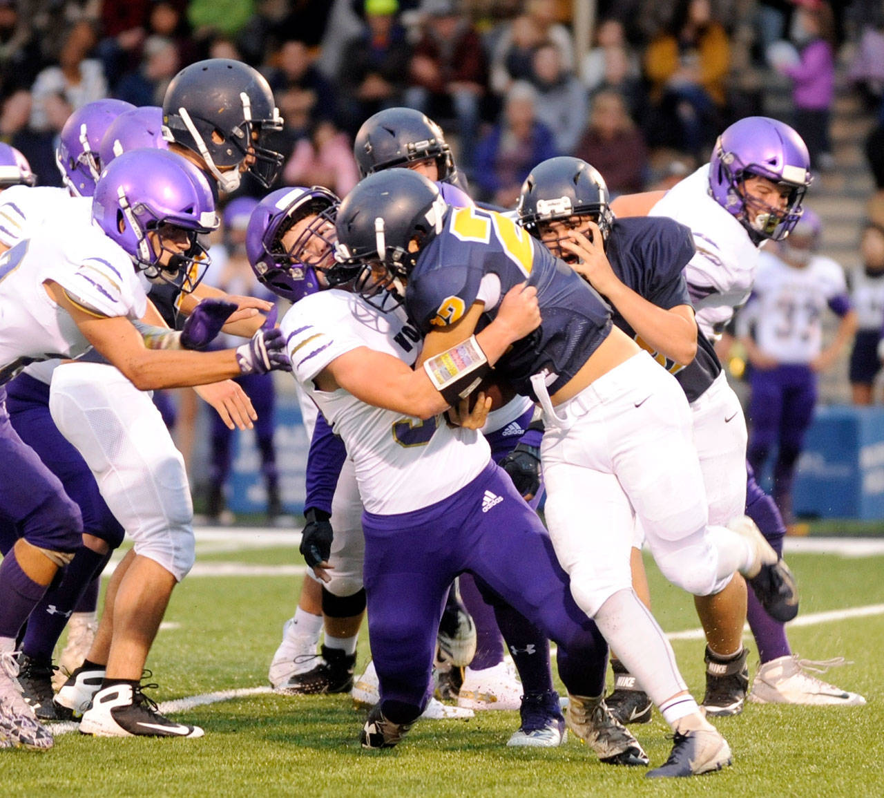 Sequim linebacker Isaiah Cowan makes a stop on Forks running back Ricardo Barragan on Friday at Spartan Stadium.