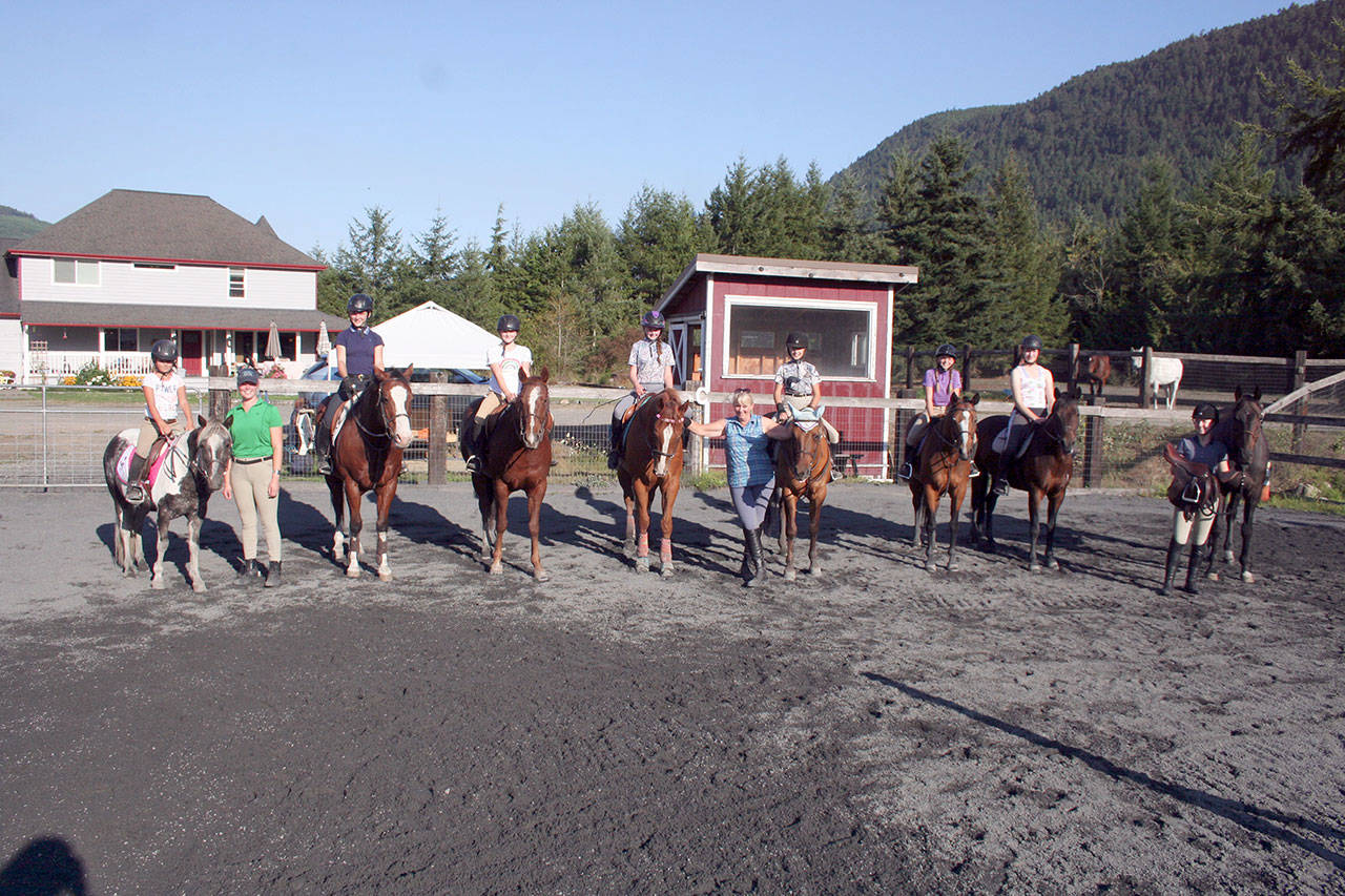 Living Well Farm owner/instructor Nancy McCaleb teaches fun, informative lessons year-round. She is shown here with some of her students. They are, from left, Alyssa Romero, Sydney Day, Sara Holland, Kennady Gilbertson, Lillian Bond, McCaleb, Jeana Hutton, Ella Garcelon, Katie Marchant and Gwyneth Van Blair. (Karen Griffiths/for Peninsula Daily News)