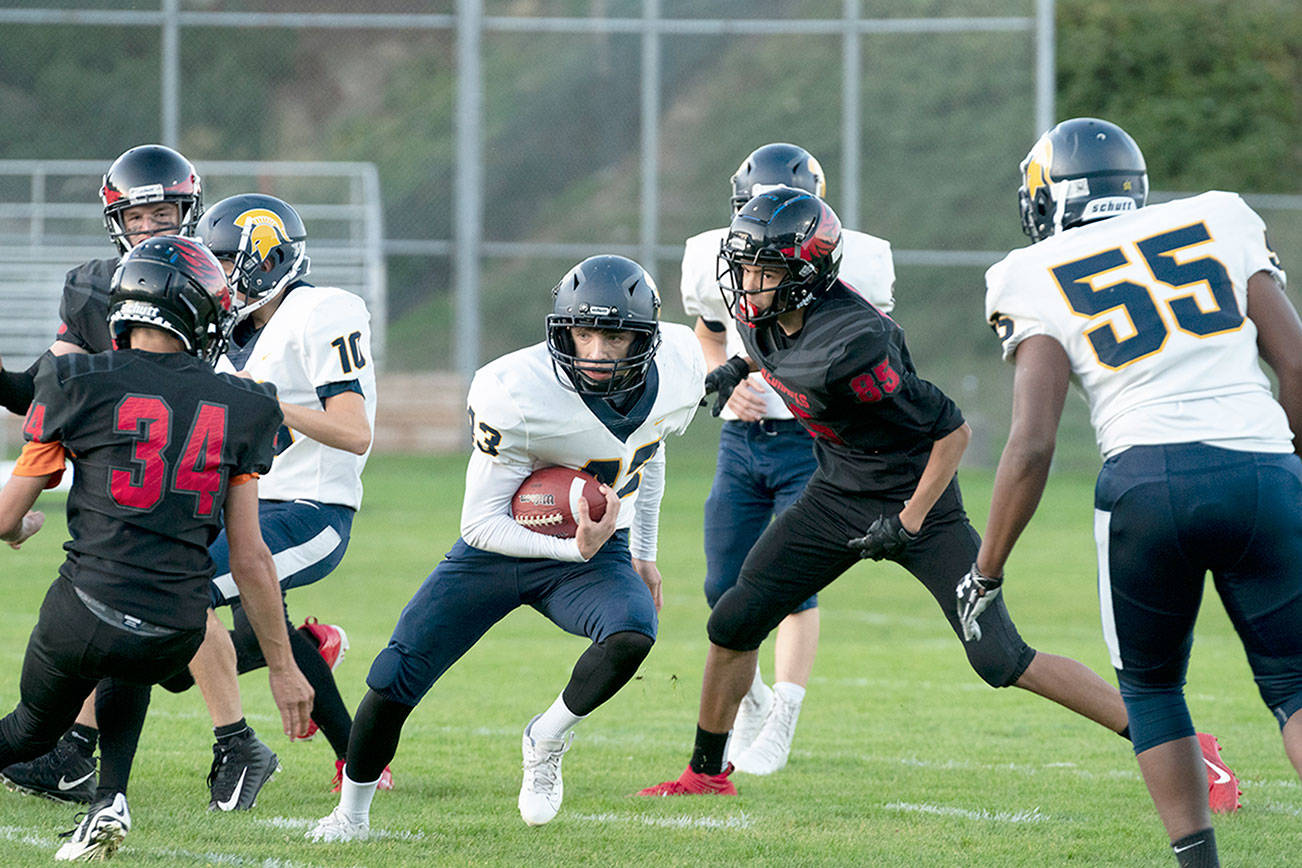 PREP FOOTBALL: Spartans’ Baker runs wild in win over Redhawks