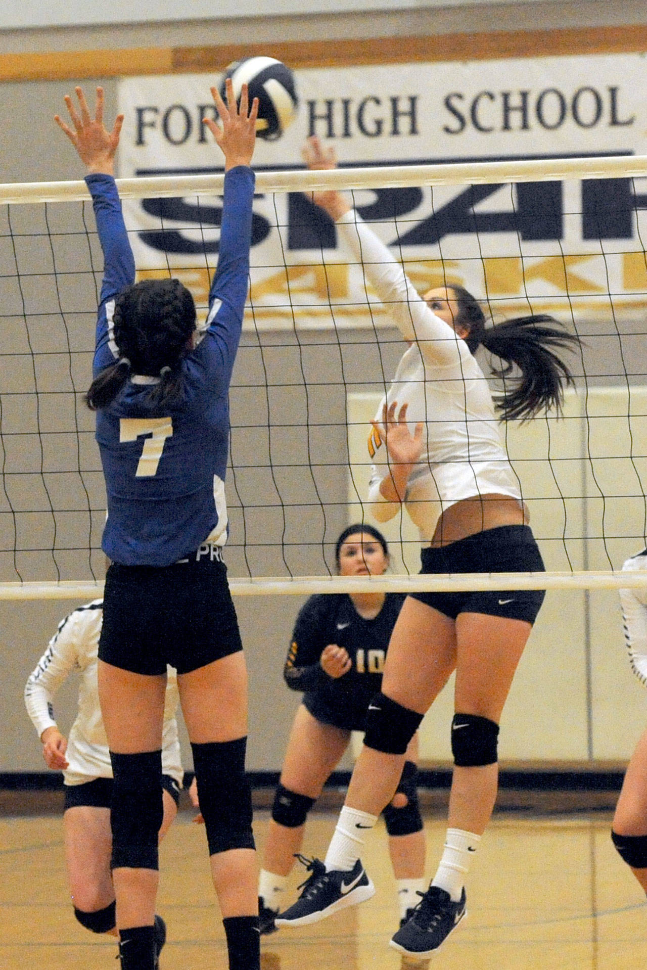 Lonnie Archibald/for Peninsula Daily News Forks’ Natalie Lausche, right, hits against Chimacum’s Jessica Hawley