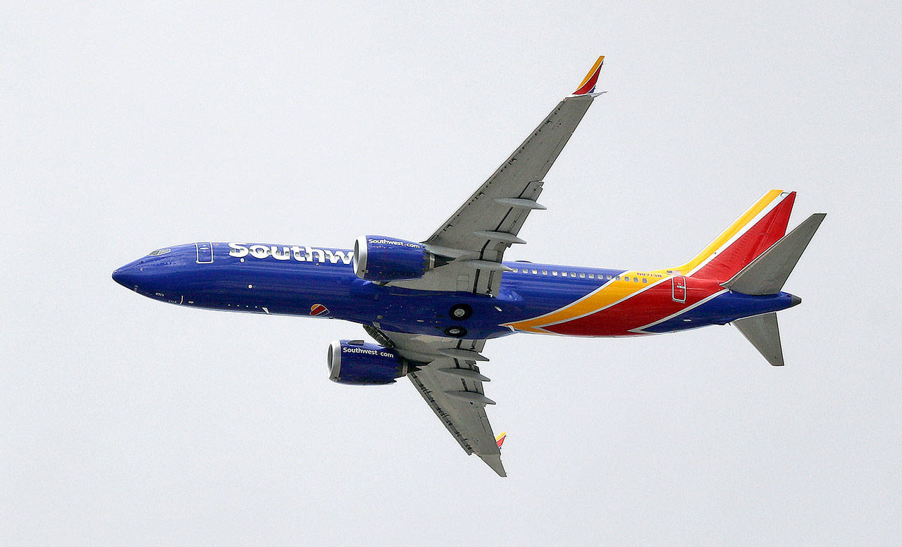 In this March 13 photo, a Southwest Airlines Boeing 737 Max 8 jet flies over Mesa, Ariz., en route to Phoenix’s Sky Harbor International Airport. (Elaine Thompson/The Associated Press)