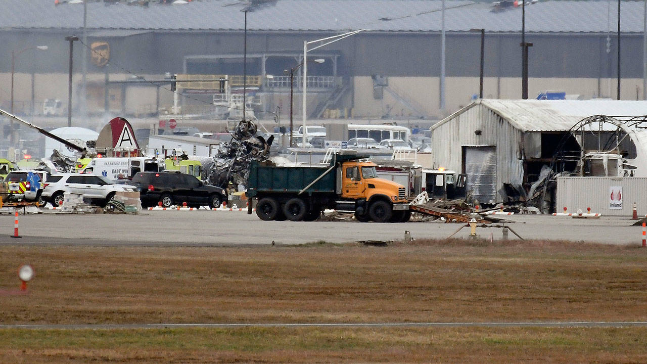 A fire-and-rescue operation was underway where a World War II-era bomber plane crashed at Bradley International Airport in Windsor Locks, Conn., on Wednesday. (Jessica Hill/The Associated Press)