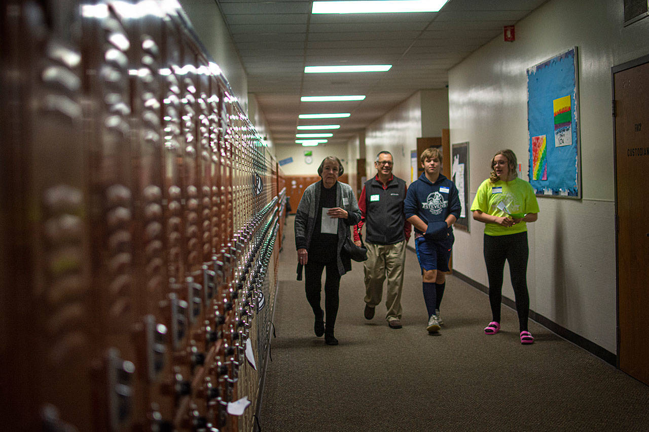 Stevens Middle School students take Karen Winther and Robert Skolnile on a tour of the building. (Jesse Major/Peninsula Daily News)